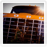 Small thumbnail photograph showing the front grill of an old orange Ford truck