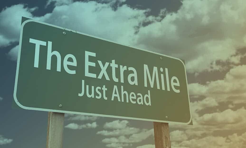 Road sign that says The Extra Mile, Just Ahead