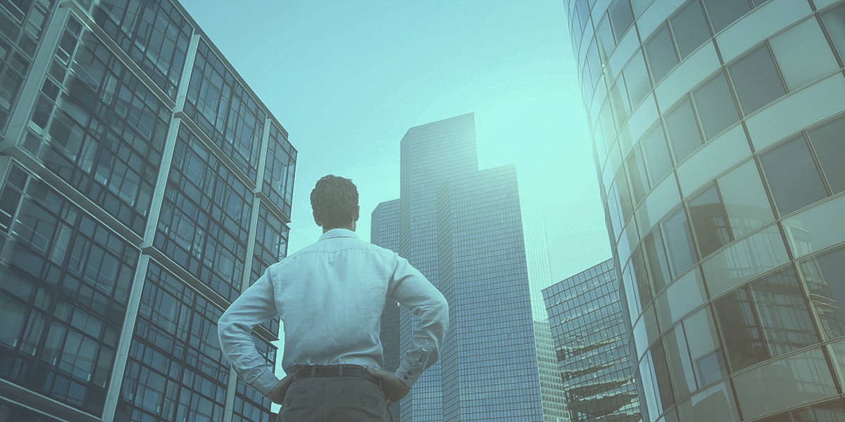 Man Gazing Up at Skyscrapers