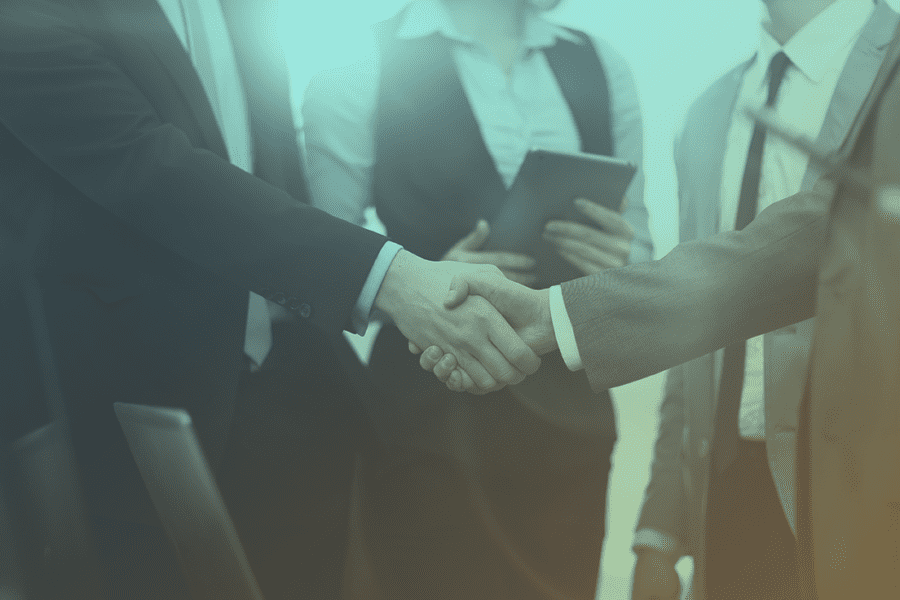 Shaking hands to secure a business deal among a group of business people