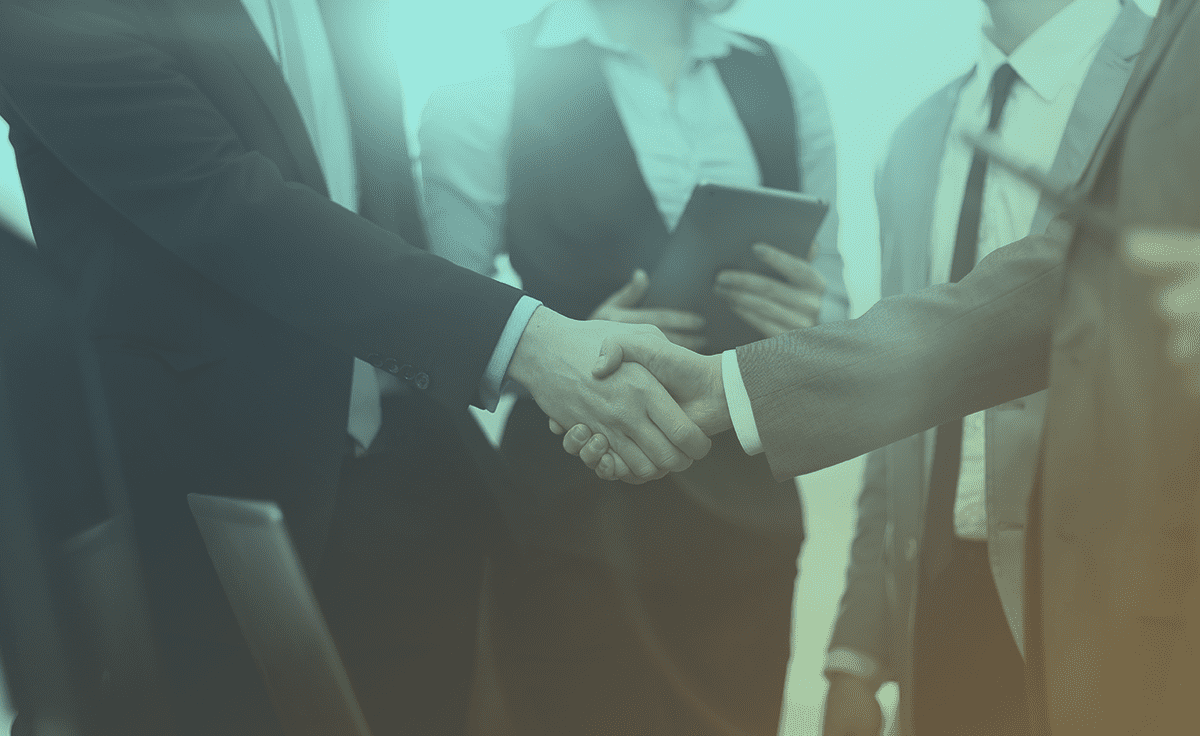 Shaking hands to secure a business deal among a group of business people