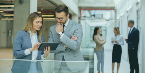 two business people consulting over a tablet computer