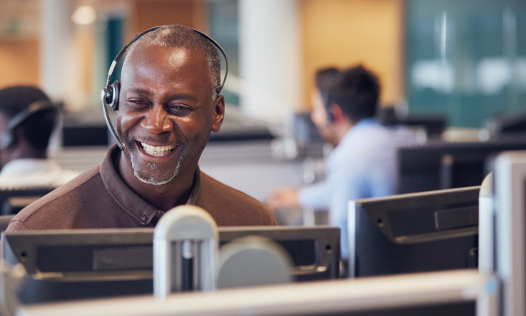 Freight broker happy at his computer.