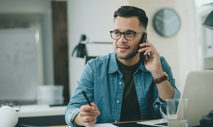 Freight broker on the phone referring a client.