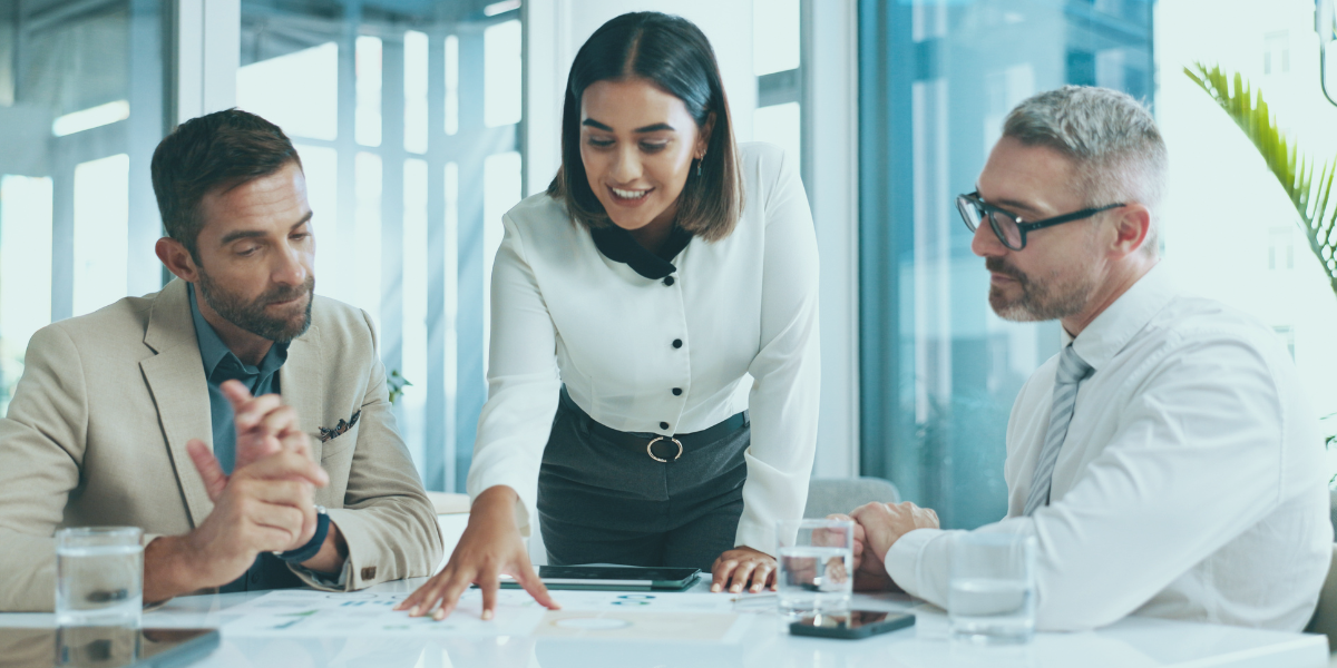 Business woman explaining how to prepare for unexpected events to two business owners.