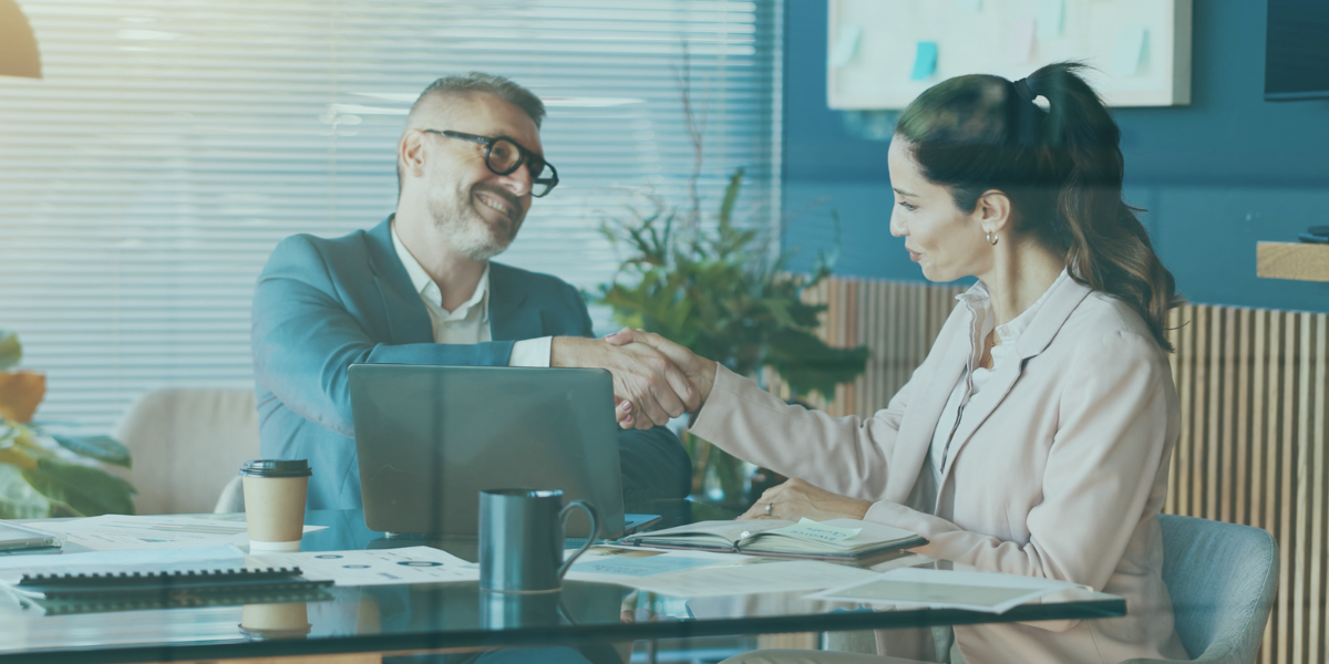 Staffing firm recruiting an employee in a boardroom with a handshake.
