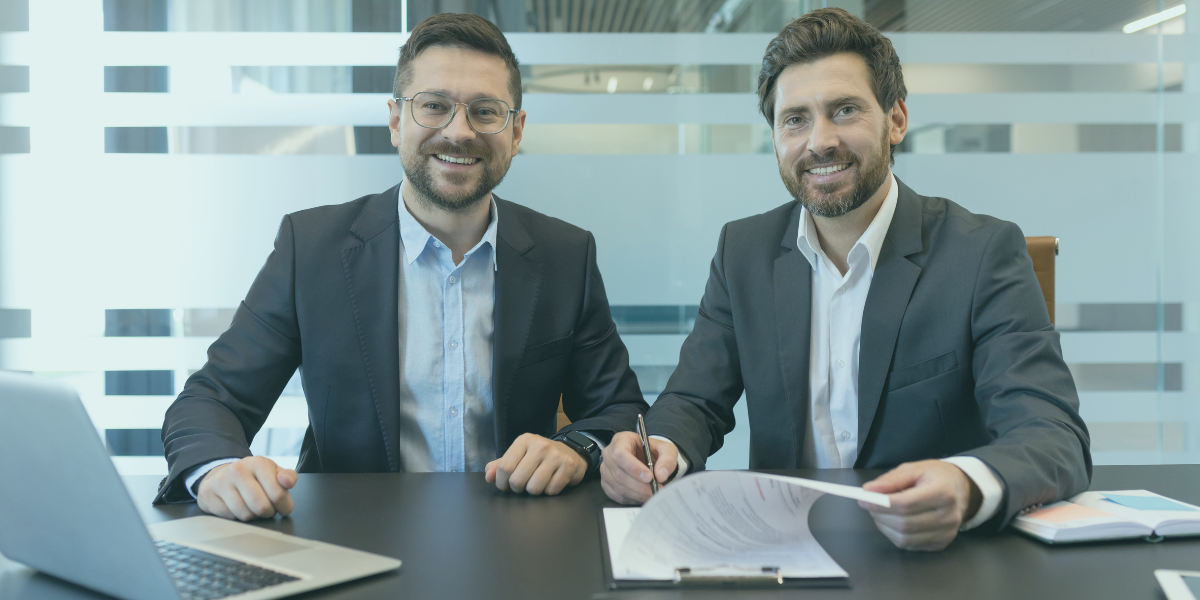 Two men sitting together discussing bank carve out.