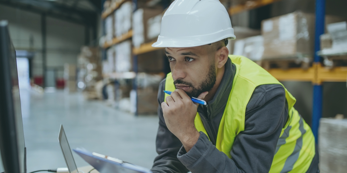 Man looking at a computer trying to reactivate his DOT number.