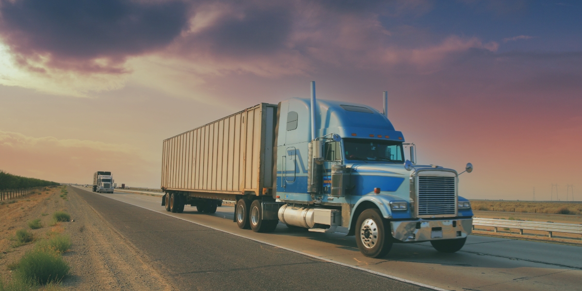 Two transport trucks driving.